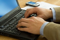 bigstock-Business-Man-Writing-On-Laptop-302774